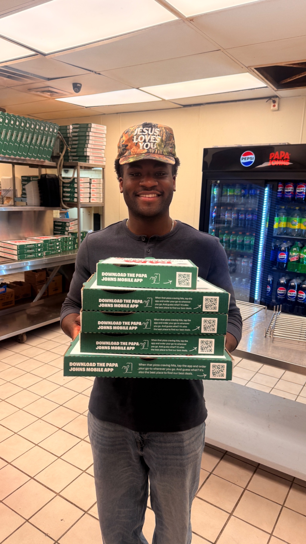 Daniel receiving a stack of pizza boxes